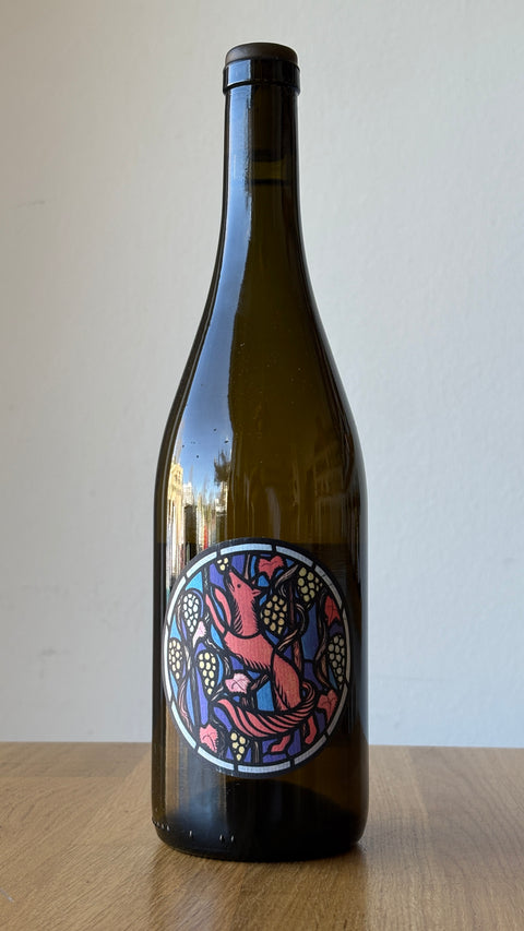 A bottle of Riesling wine with a colorful, artistic label designed by Julien Renard.